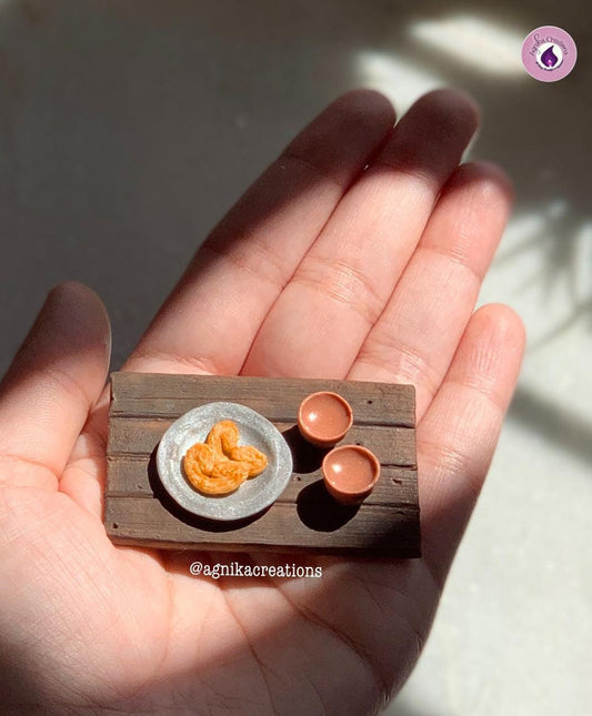 Miniature Prajapati (butterfly shaped) Biscuits with Bharer Cha (tea served in earthen pots)